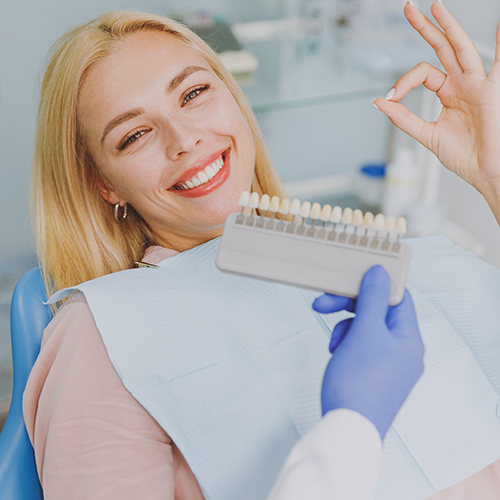 Smile Makeovers - a woman in a dental chair smiling